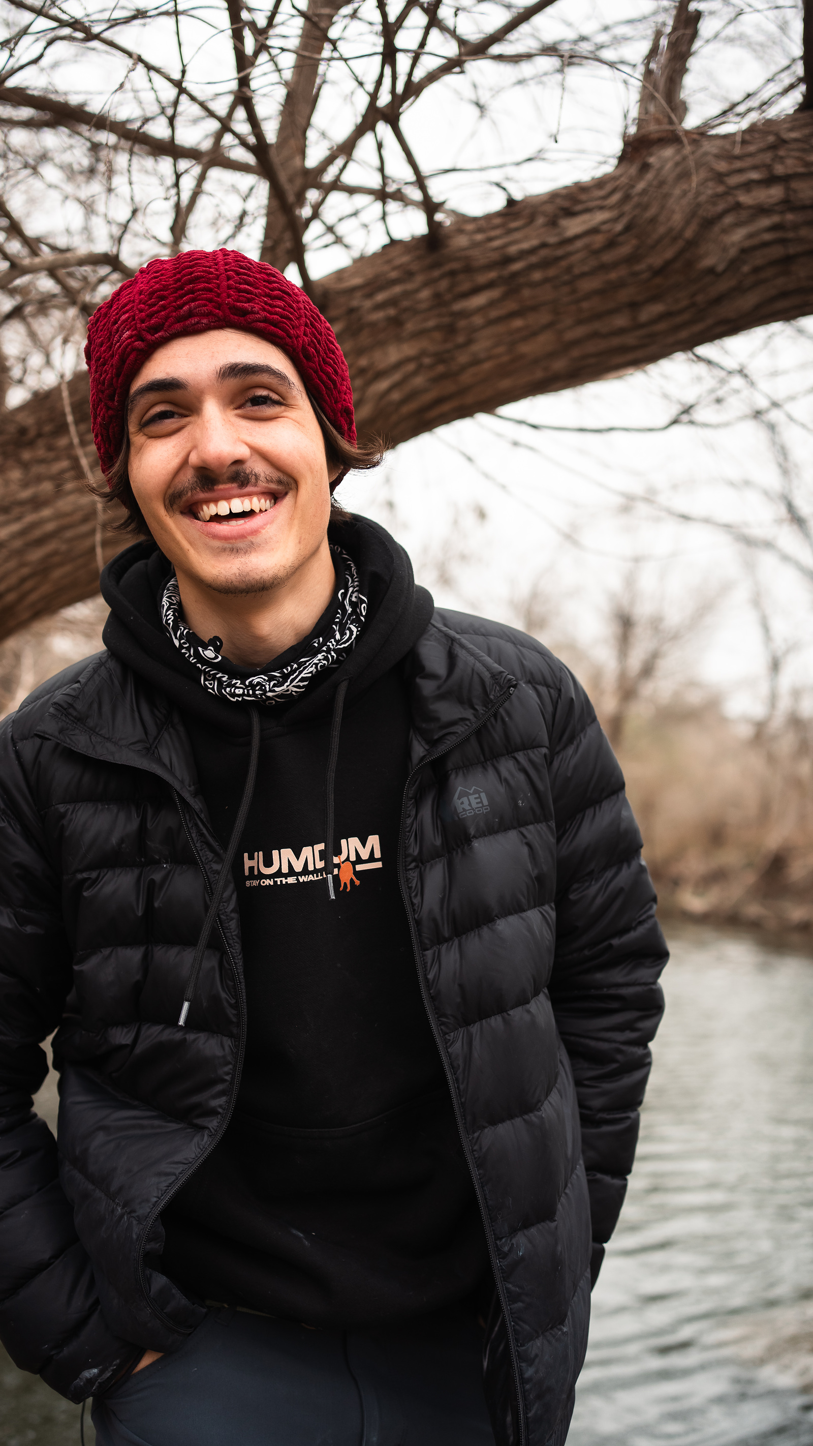 John smiling outdoors in beanie and hoodie
